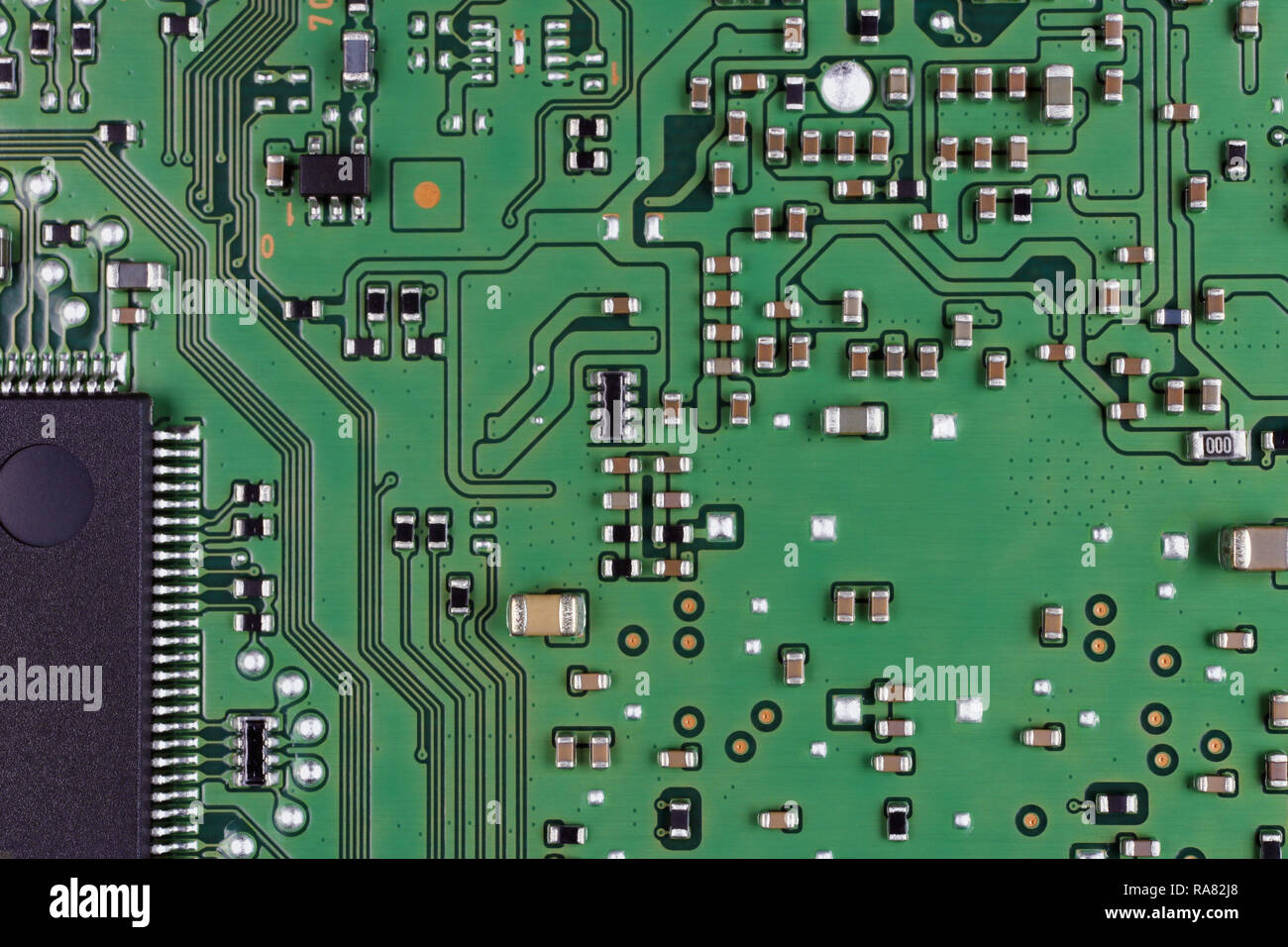 Microchips and microcircuits are installed on a modern electronic circuit board.  Mass production. Super macro studio concept Stock Photo
