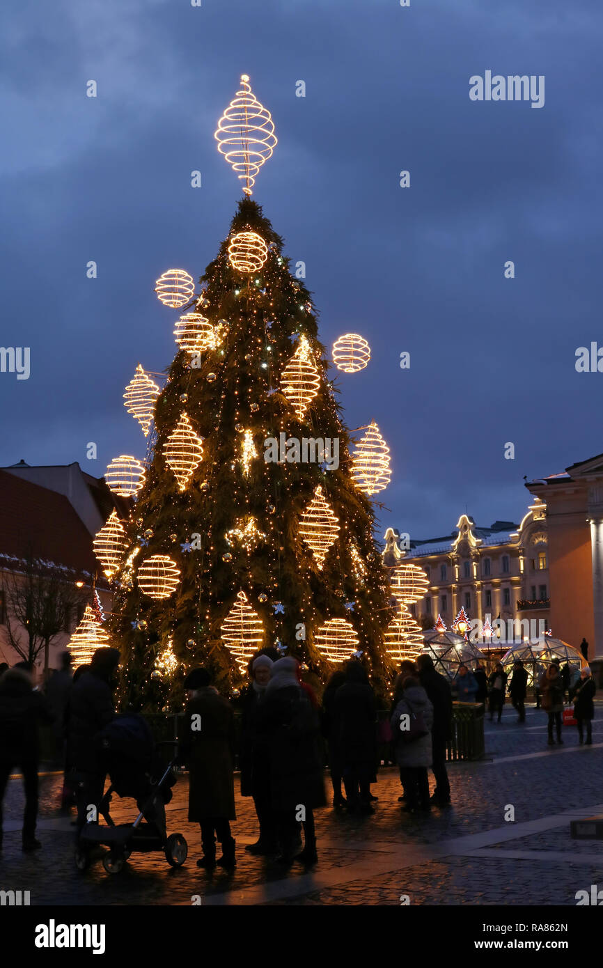 VILNIUS, LITHUANIA - DECEMBER 26, 2018: Christmas European  city square and decorated illuminate fir tree on  European old town. People celebrate Xmas Stock Photo