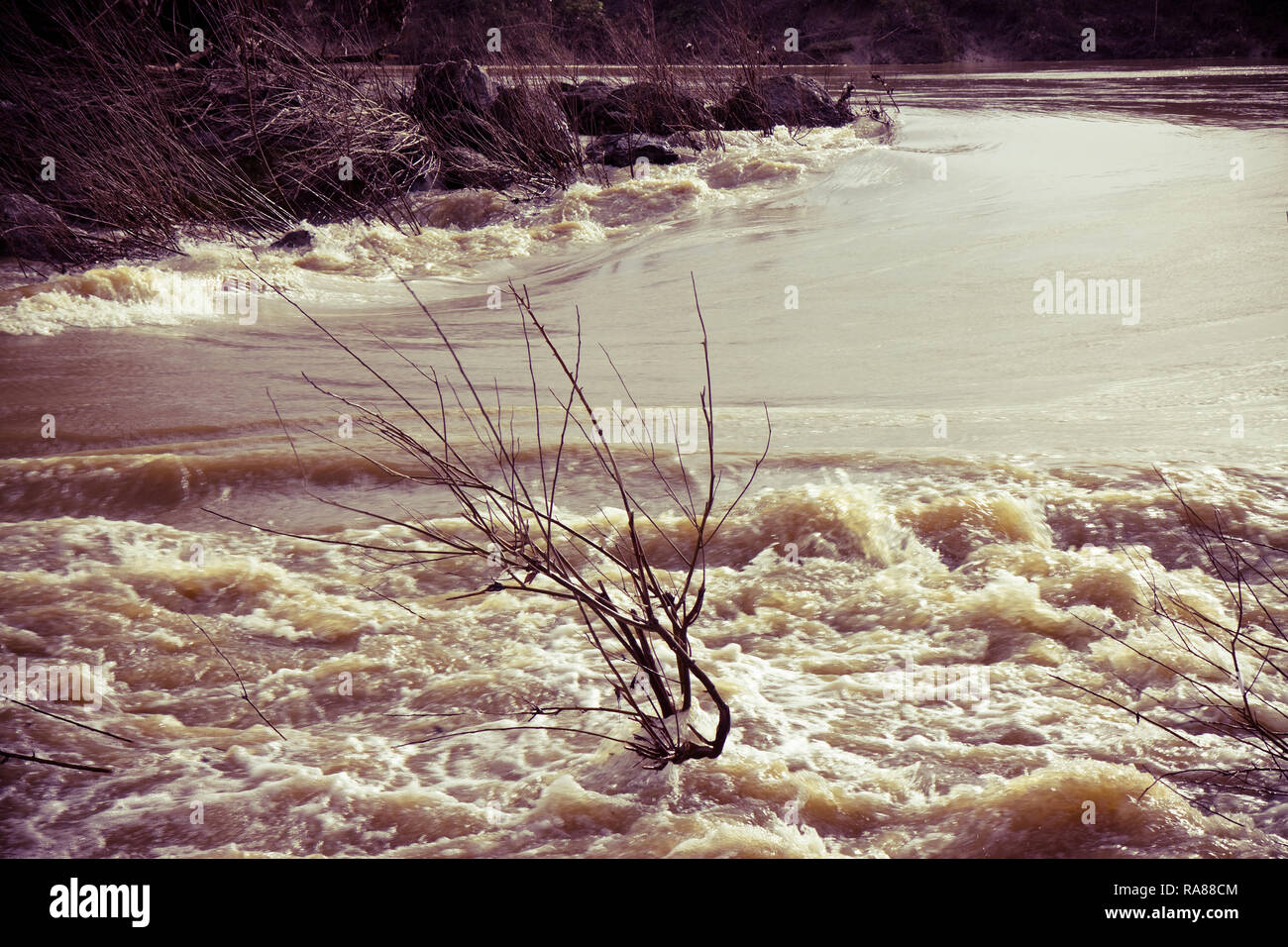 Rushing waters of a swollen river during the rainy season. Flooding