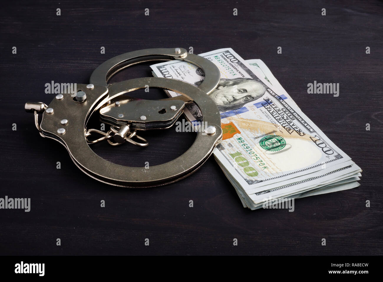 Handcuffs and money. Dollars for bail bonds. Stock Photo