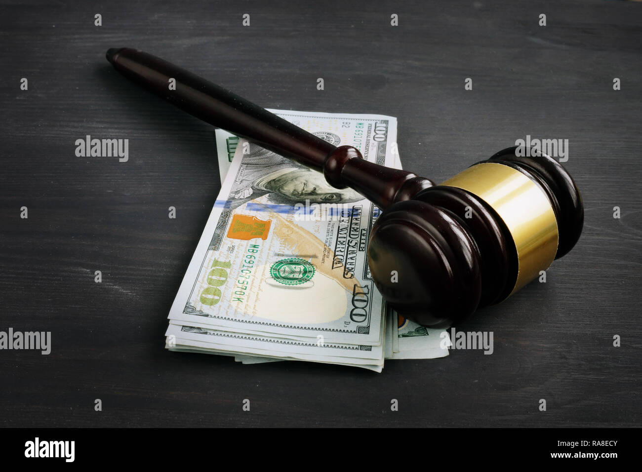 Gavel and money in the court. Penalty or bribe. Stock Photo