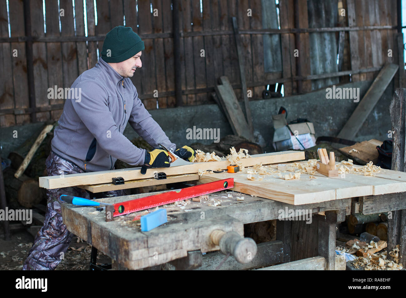 Woodworking - man using hand planer on a pine wood Stock Photo