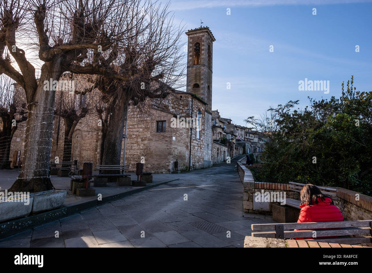 COLLE VAL D’ELSA, ITALY - DECEMBER 26, 2018: Unknown woman near the church of Santa Caterina in the medieval village of Colle di Val d'Elsa, Siena, Tu Stock Photo