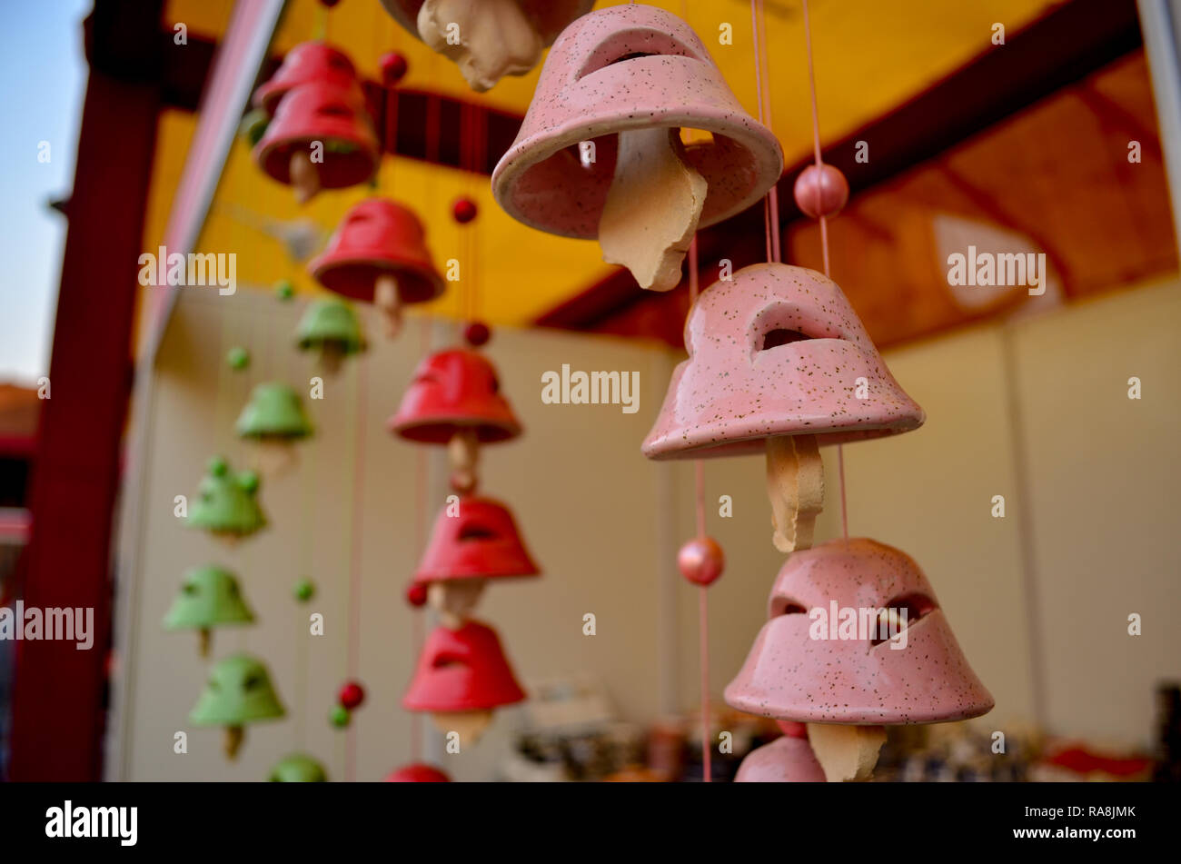 Colorful wind chimes in shape of a temple bell made of clay hanging