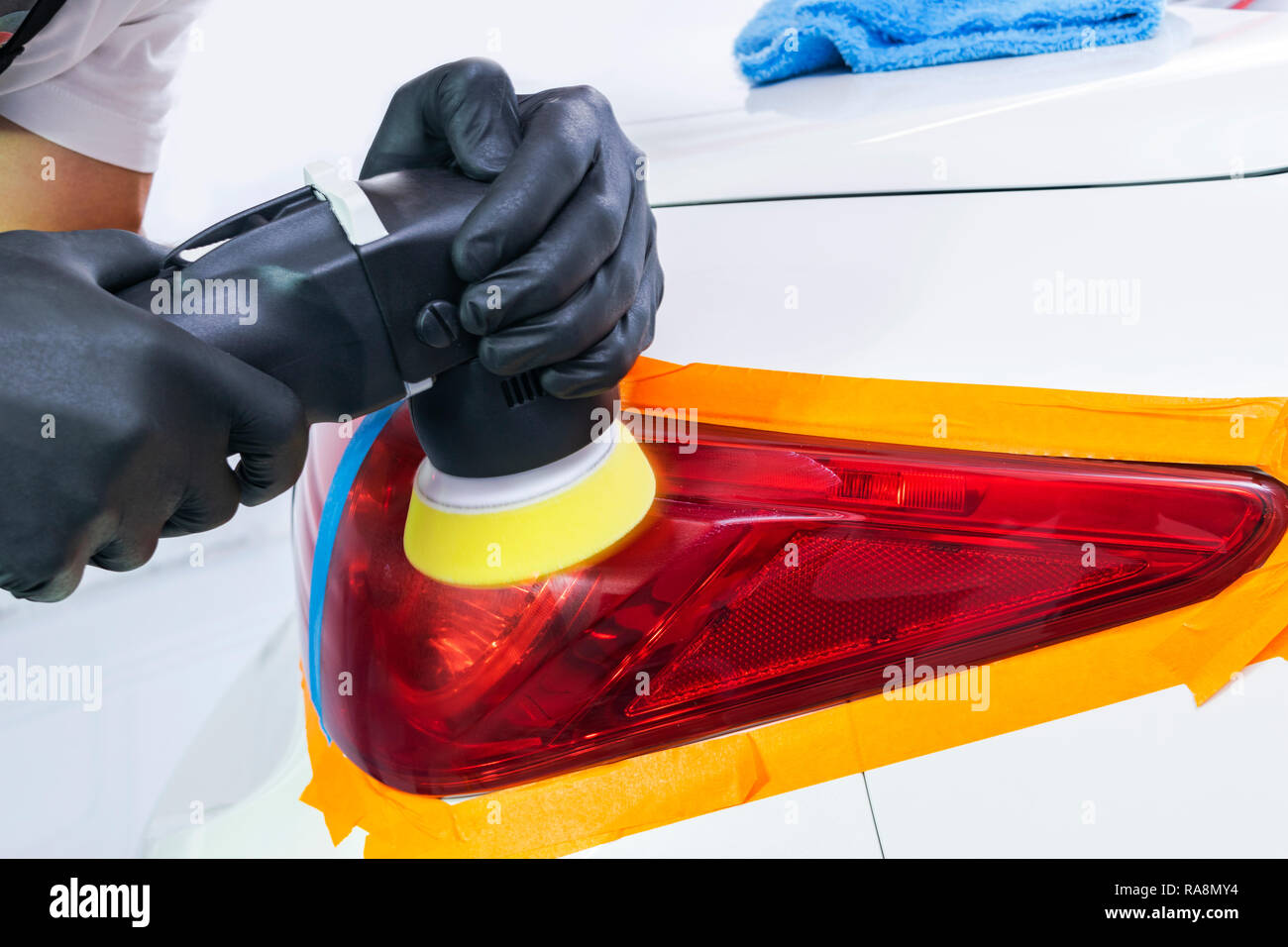 Car polish wax worker hands applying protective tape before polishing.  Buffing and polishing car. Car detailing. Man holds a polisher in the hand  and Stock Photo - Alamy