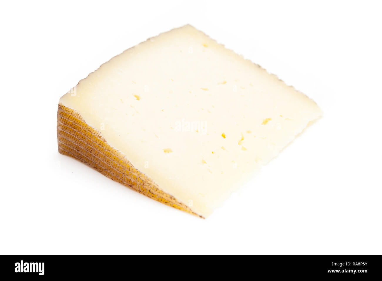 Spanish Manchego cheese made from sheep's milk it has a firm and creamy texture, isolated on a white studio background. Stock Photo