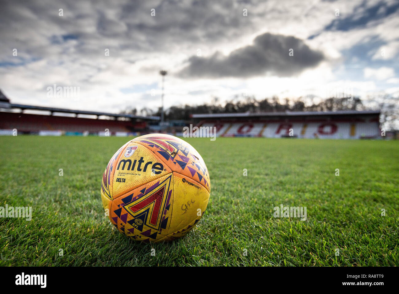 Close up of official EFL League Two football on pitch with stand in background Stock Photo
