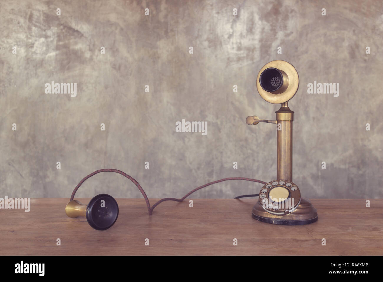 Vintage telephone on wooden table with cement wall background Stock ...