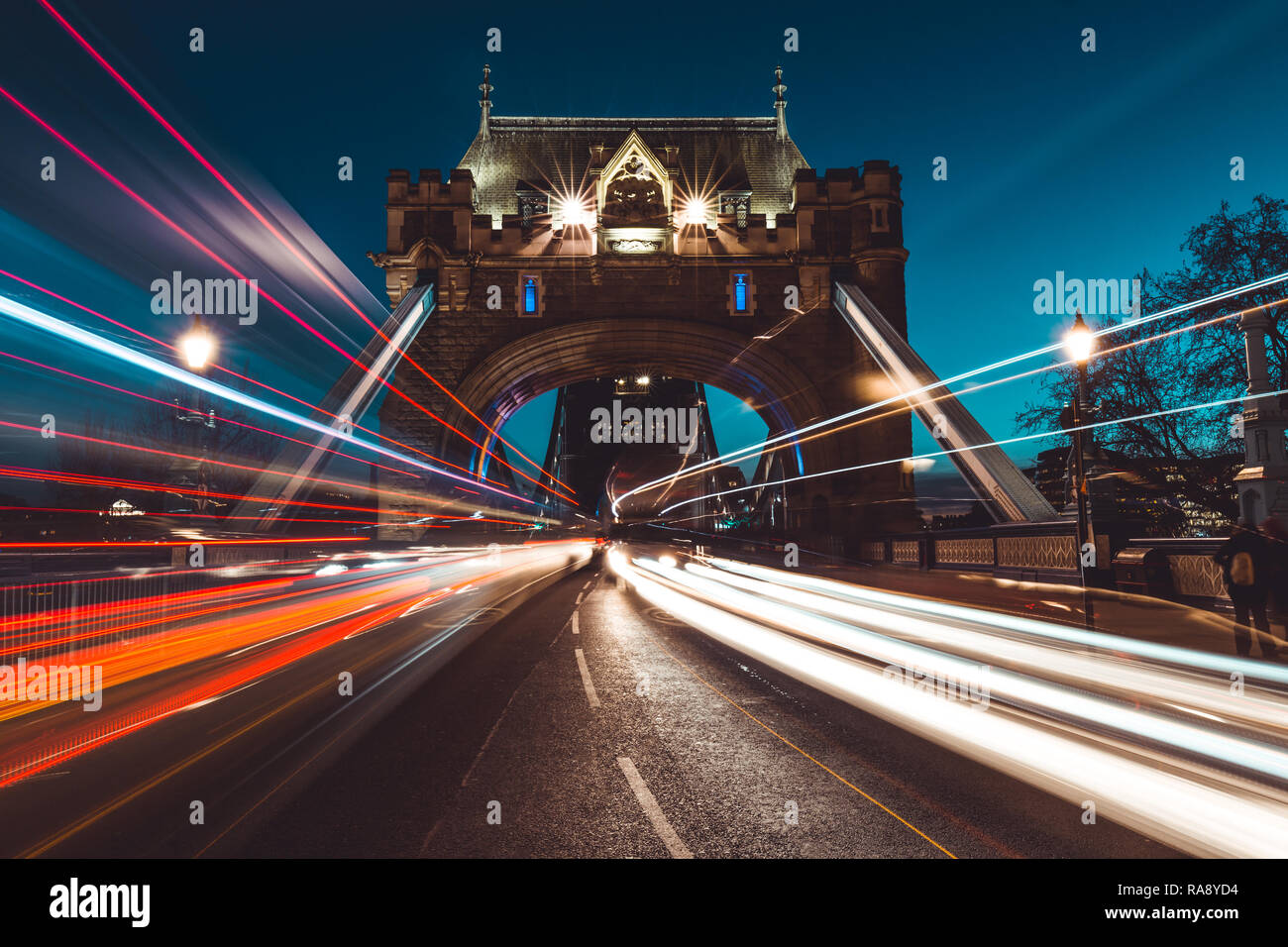 Traffic light trails on Tower Bridge in London city skyline at night ...