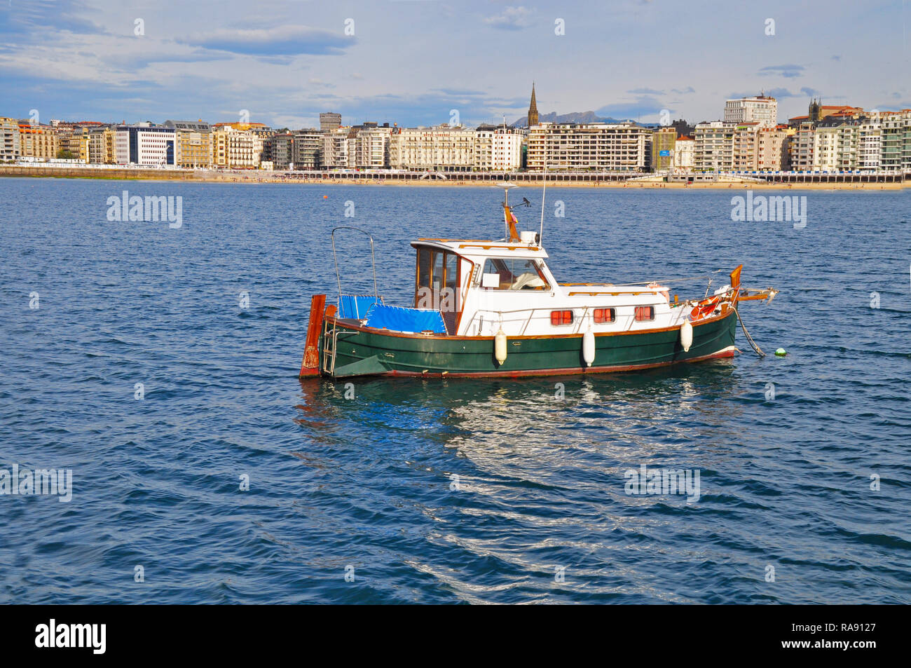 little boat fishing on La concha Beach, San sebastian, Spain Stock Photo