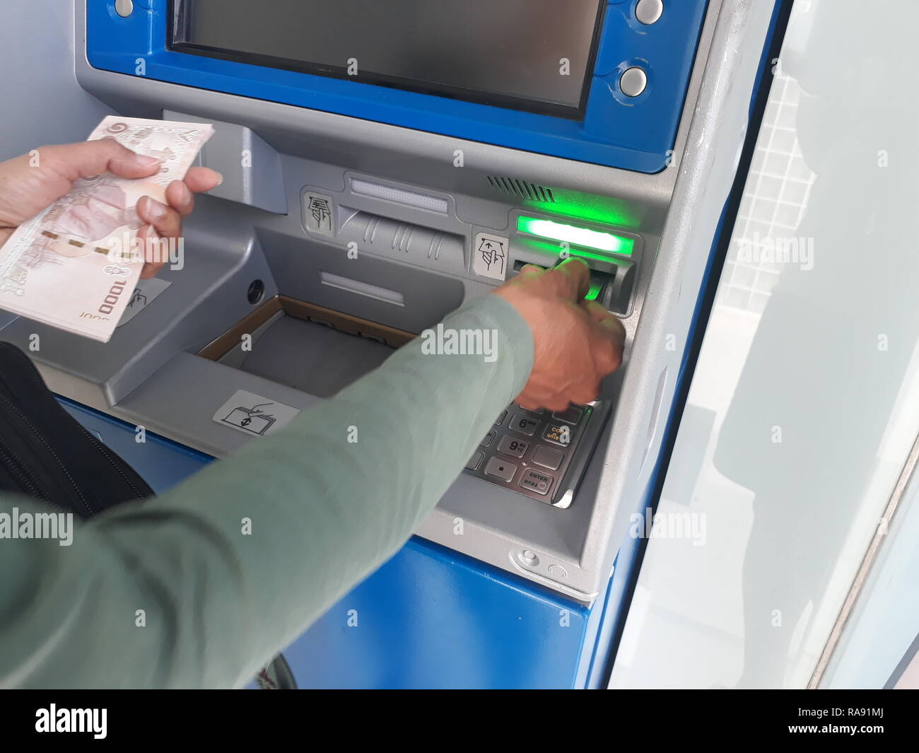 withdraw money from ATMs Stock Photo