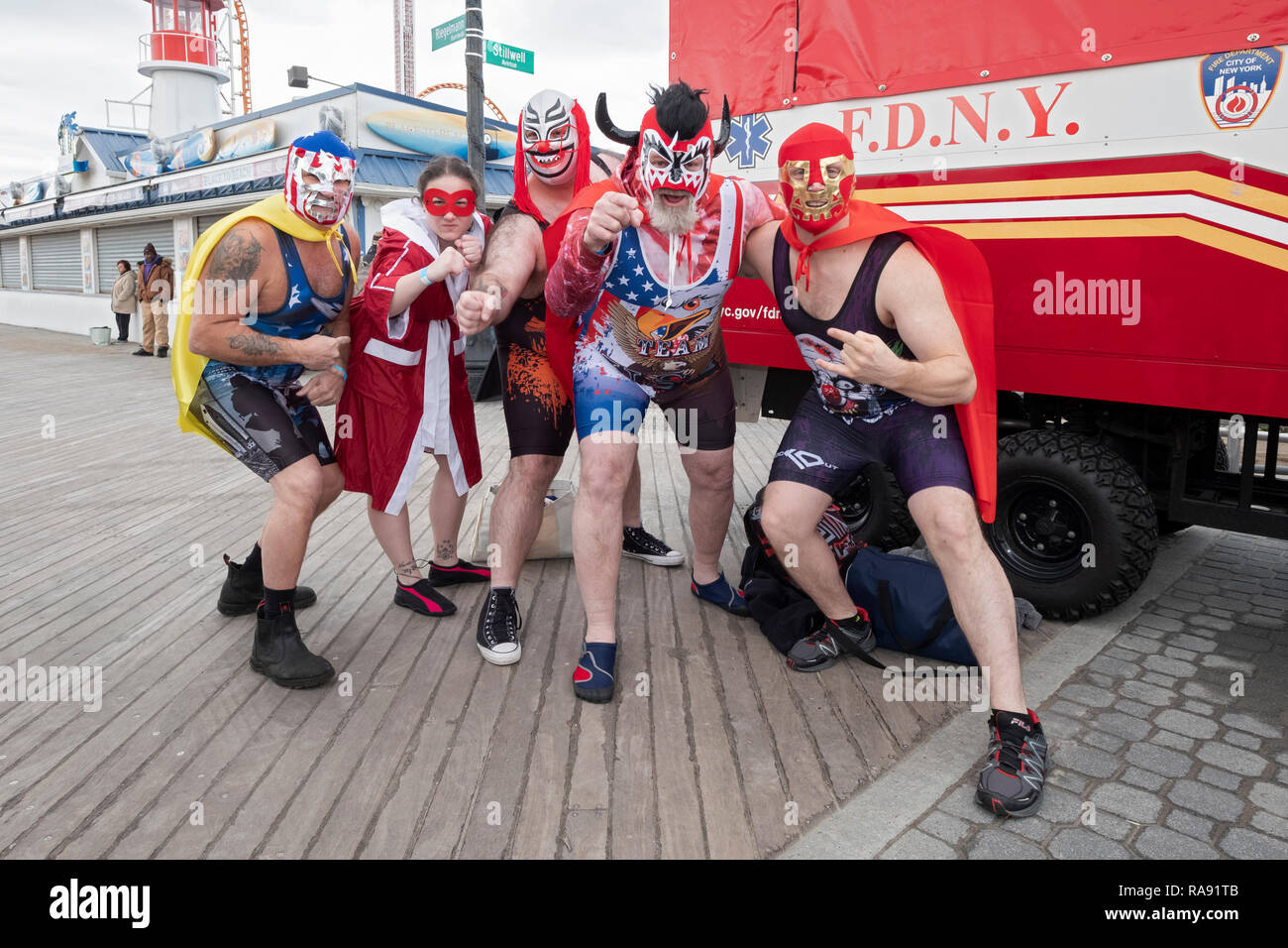 4 men and a woman dressed as wrestlers prior to the annual Polar Bear Club New Year's day swim in Coney Island, NYC. Stock Photo