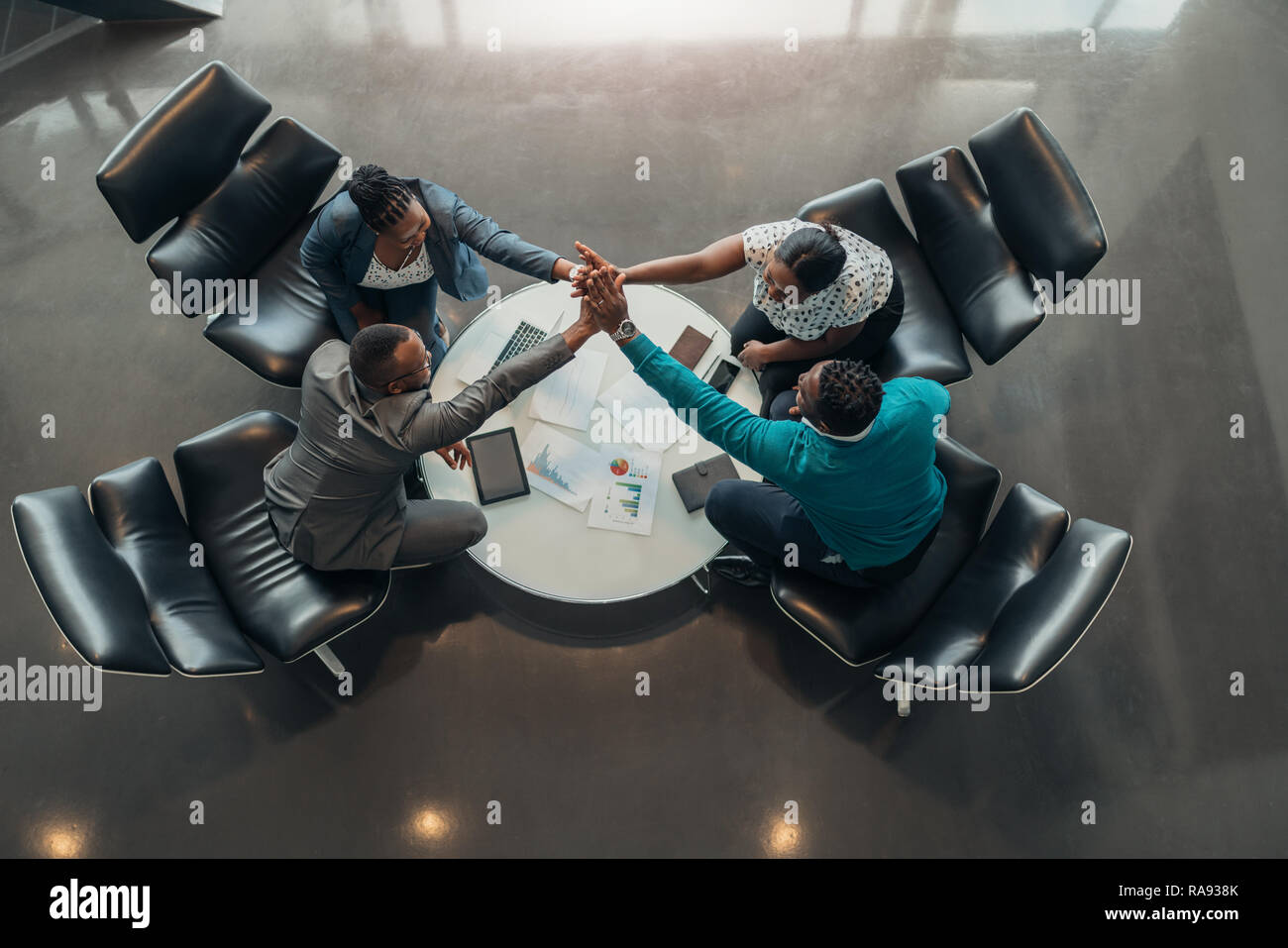 Friendly successful all african business team give high five together in office, excited happy employees celebrating corporate victory, african worker Stock Photo