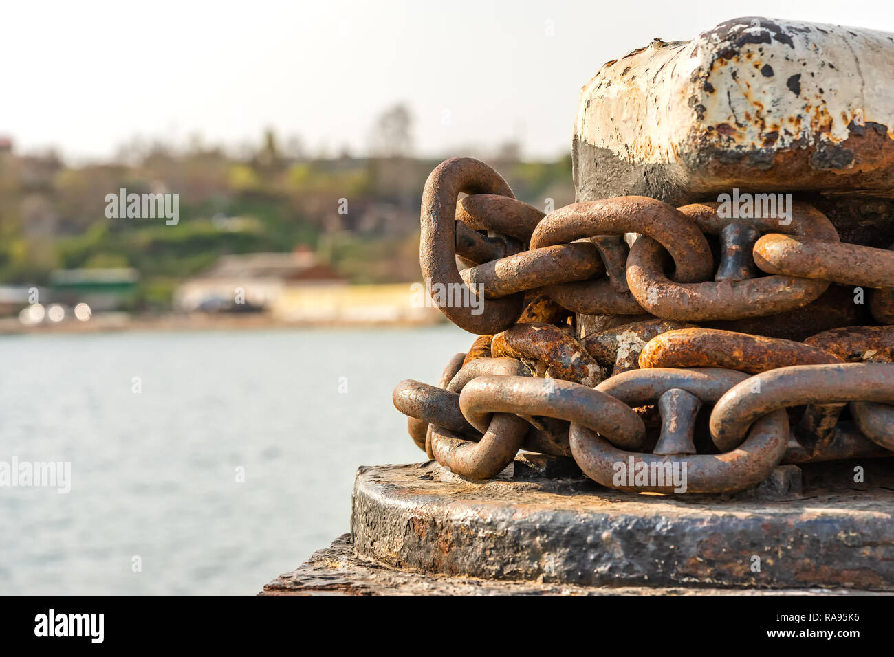 rusty anchor chain around the bollard Stock Photo