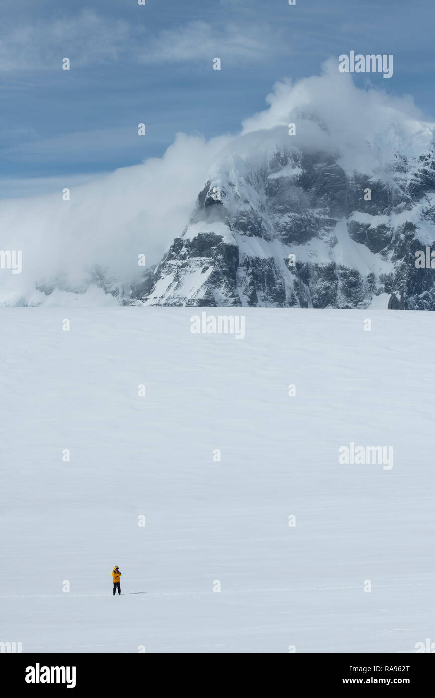 Antarctica, Gerlache Strait, Palmer Archipelago, Wiencke Island, Damoy Point.  Adventure tourist hiking in snow covered scenic landscape. Stock Photo