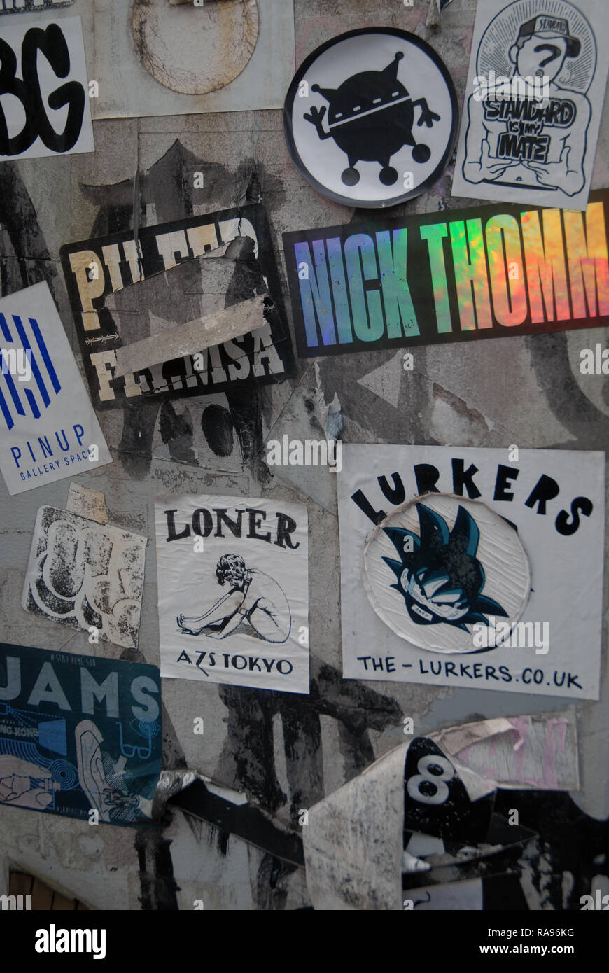 Assorted stickers stuck on lamp posts, Tokyo, Japan Stock Photo Alamy