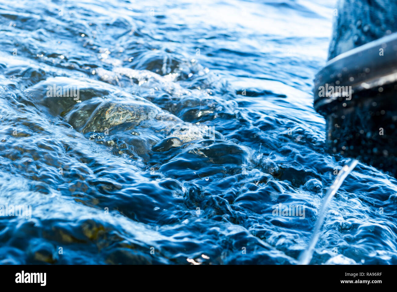 Blue ocean sea water wave with fast yacht boat wake foam of prop wash