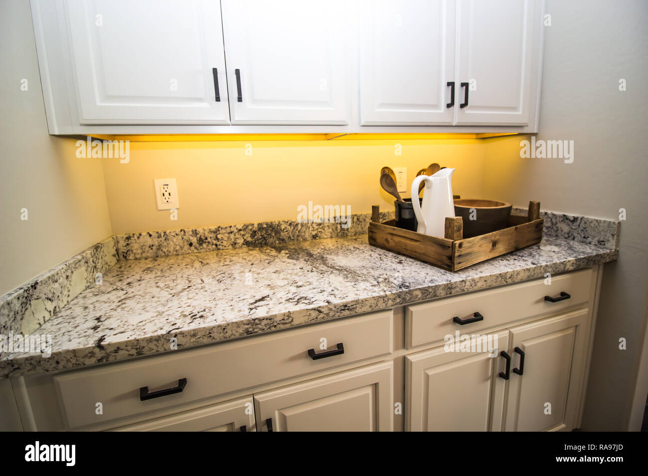 Under Cabinet Granite Counter With Rustic Tray Of Kitchen Utensils