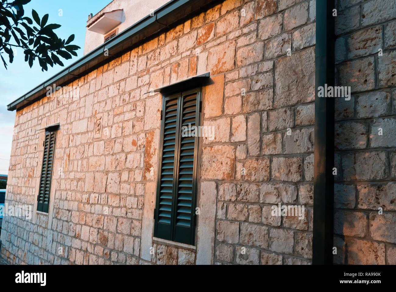 Exterior facade of old farm in sunset . Stock Photo