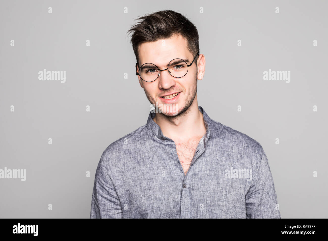 Portrait of handsome young man isolated on gray background Stock Photo ...
