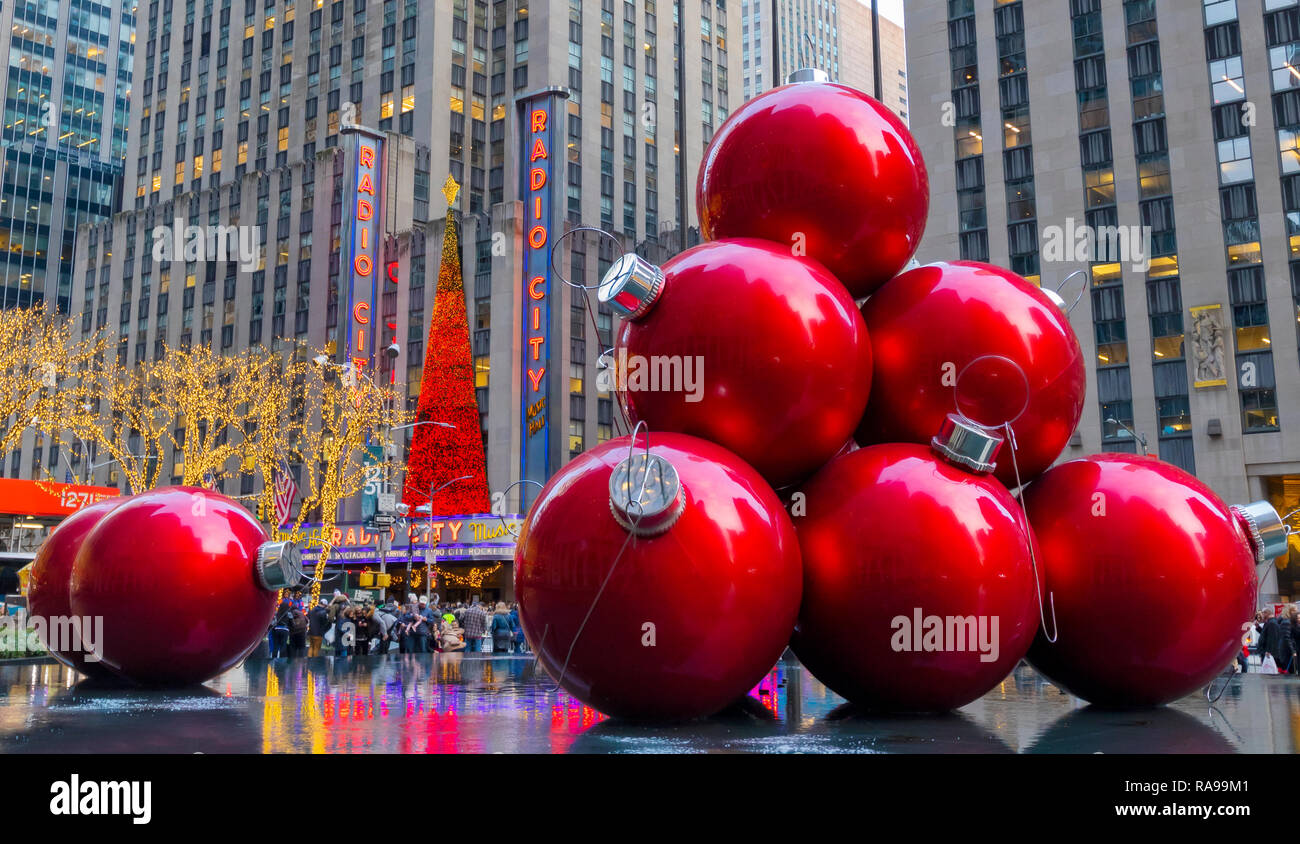 Giant Red Christmas Ornaments near Radio City Music Hall on 6th Avenue, New York City. Stock Photo