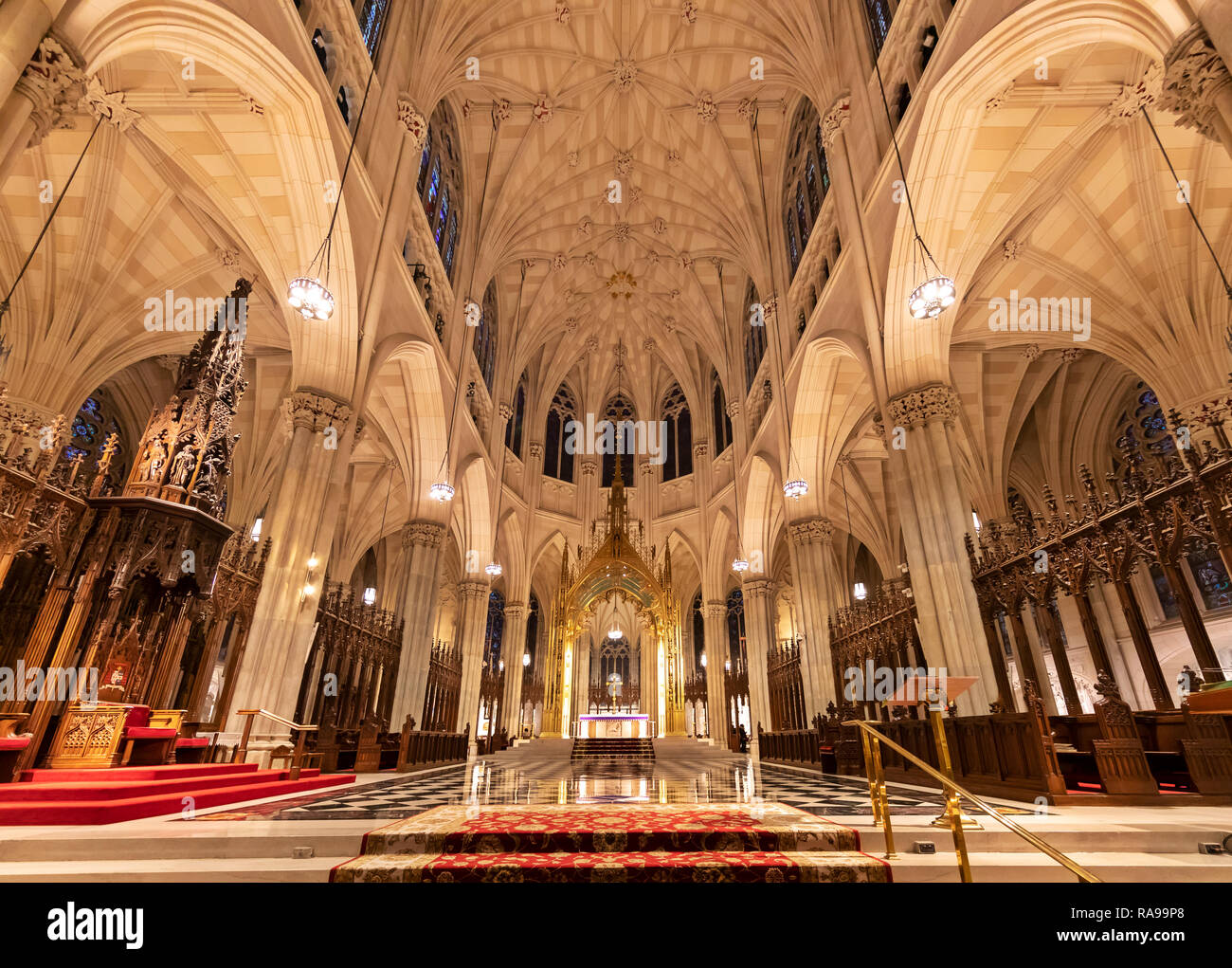 Interior view of tourists and the faithful visiting St. Patrick's Catheldral, New York City. Stock Photo