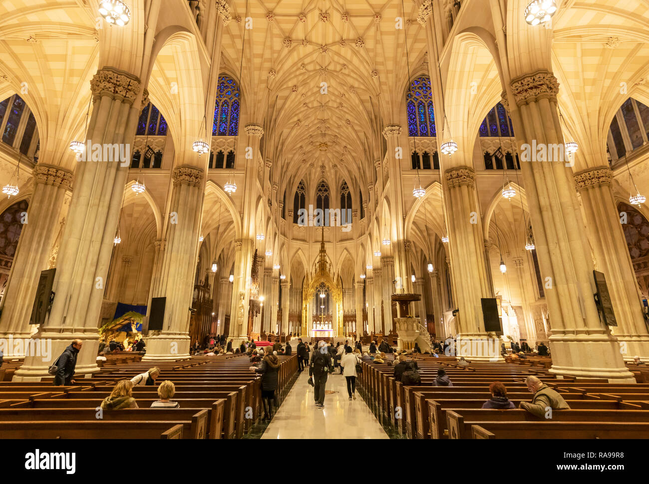 Interior view of tourists and the faithful visiting St. Patrick's Catheldral, New York City. Stock Photo