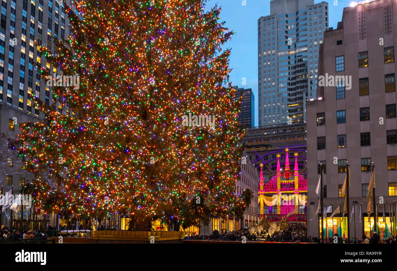 The Christmas Tree at Rockefeller Center surrounded by the angels, tourists, visitors and buildings. Stock Photo