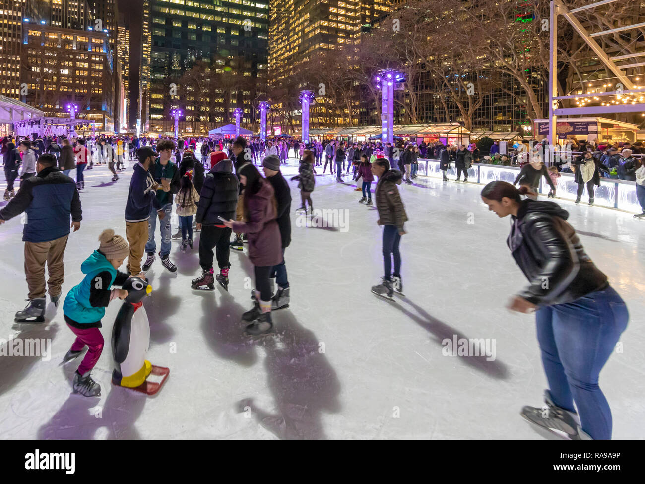 Ice Skaters at Ice skating rink at the Bryant Park Holiday Market in Bryant Park, New York City. Stock Photo