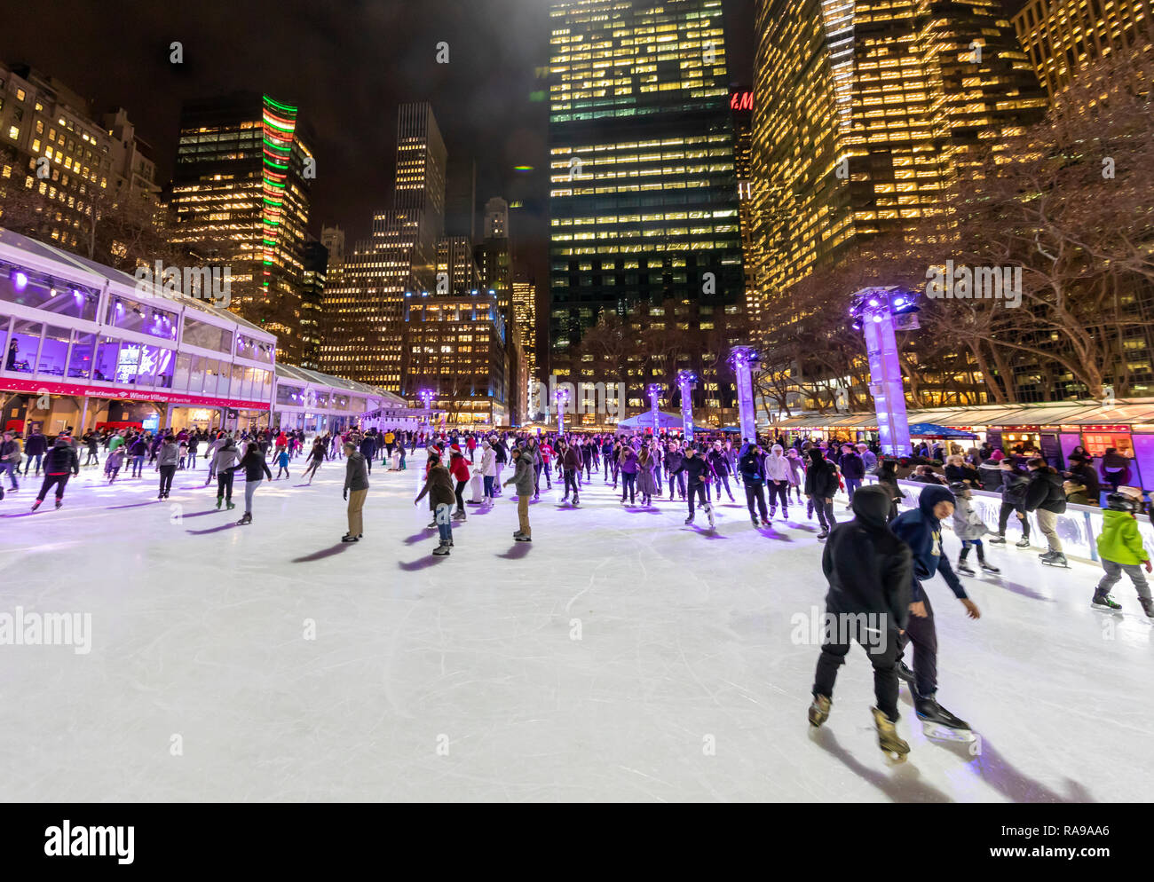 Ice Skaters at Ice skating rink at the Bryant Park Holiday Market in Bryant Park, New York City. Stock Photo