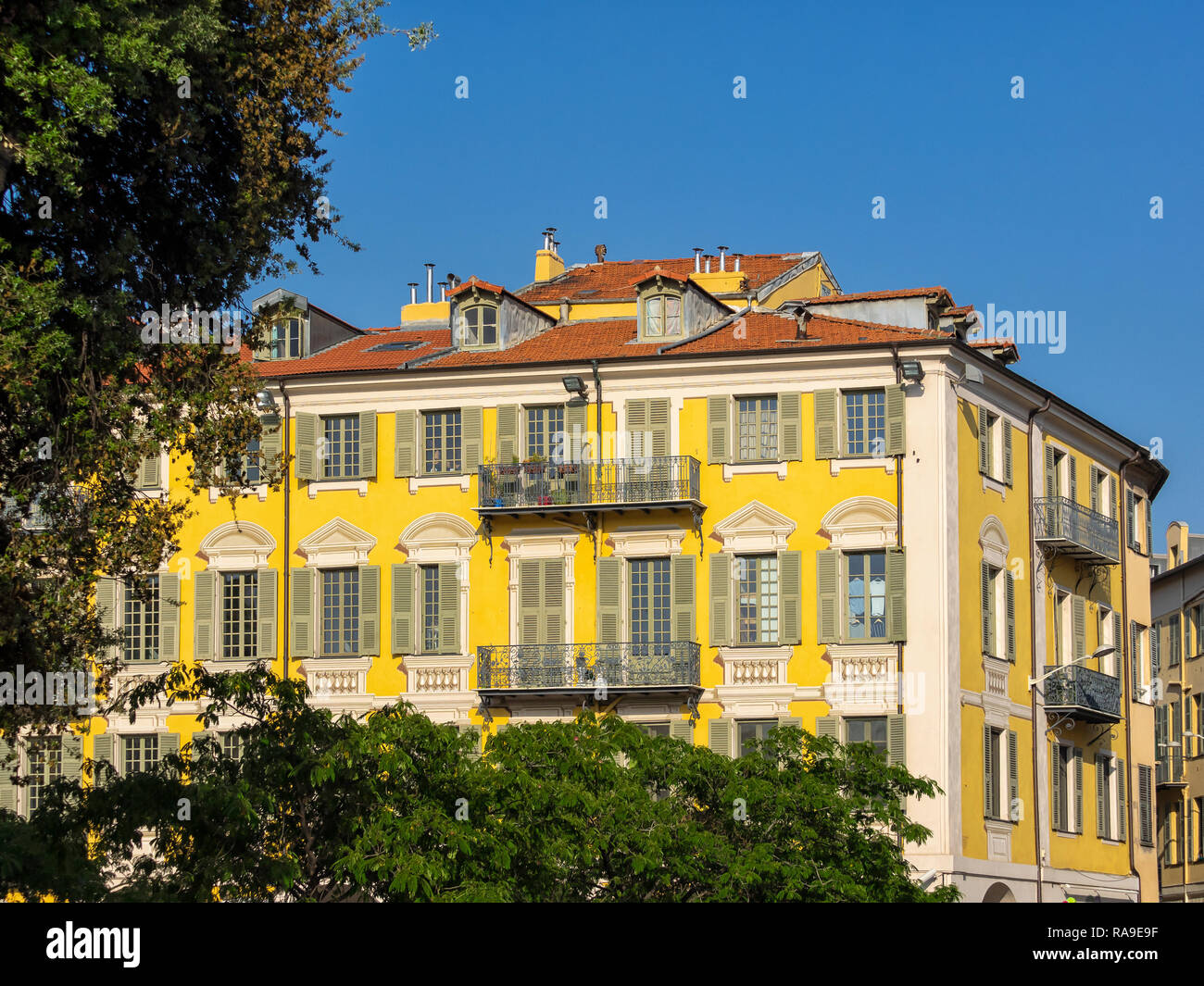 NICE, FRANCE MAY 25, 2018 Exterior view of brightly painted apartment building Stock Photo