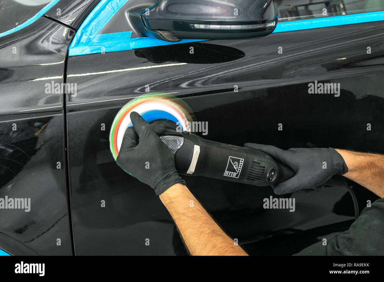 Car polish wax worker hands applying protective tape before polishing.  Buffing and polishing car. Car detailing. Man holds a polisher in the hand  and Stock Photo - Alamy