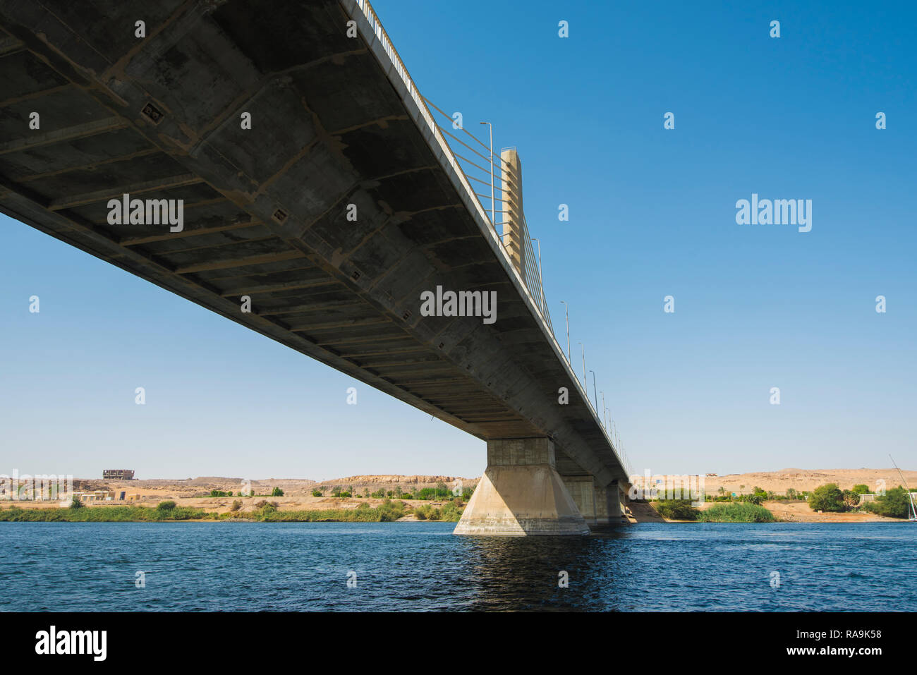 Large cable stayed road bridge spanning a wide Nile river on a clear
