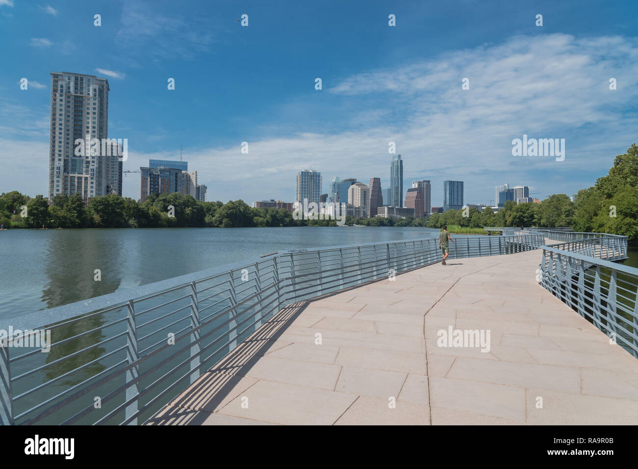 People enjoy outdoor activities on boardwalk in downtown Austin Stock