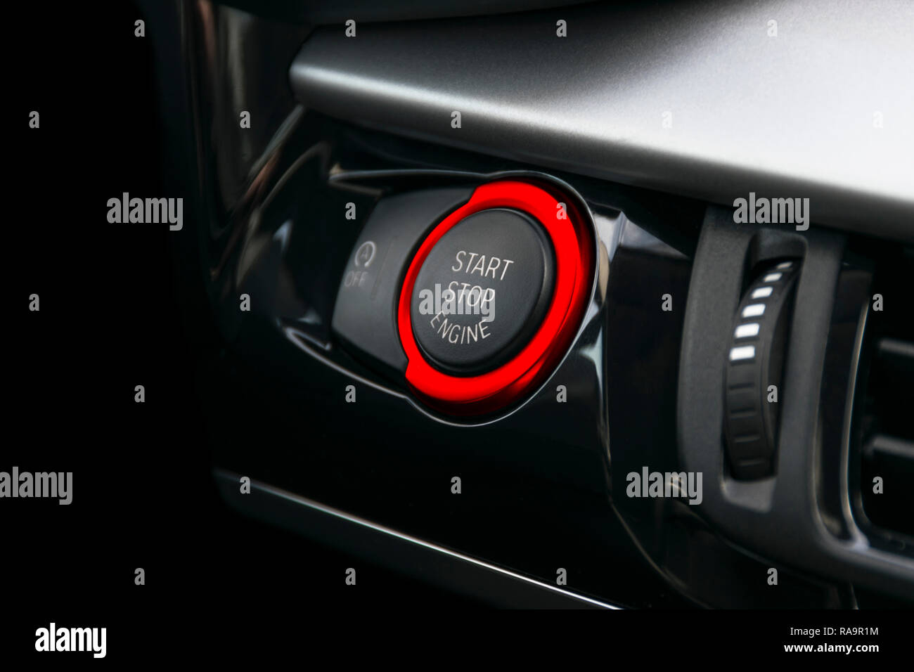 Car dashboard with focus on Red engine start stop button, car interior details Stock Photo