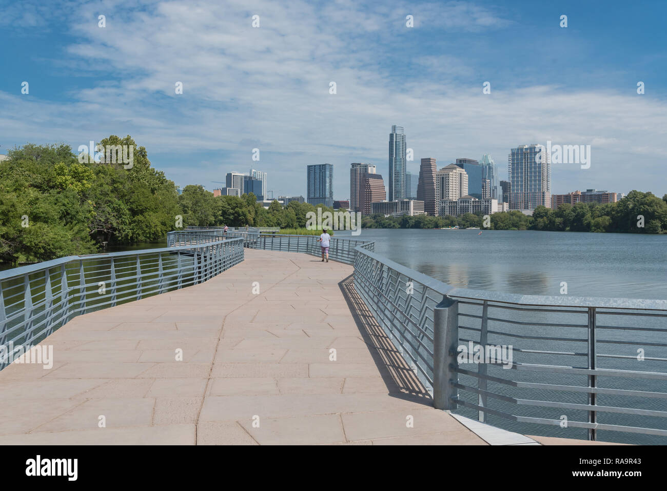 People enjoy outdoor activities on boardwalk in downtown Austin Stock