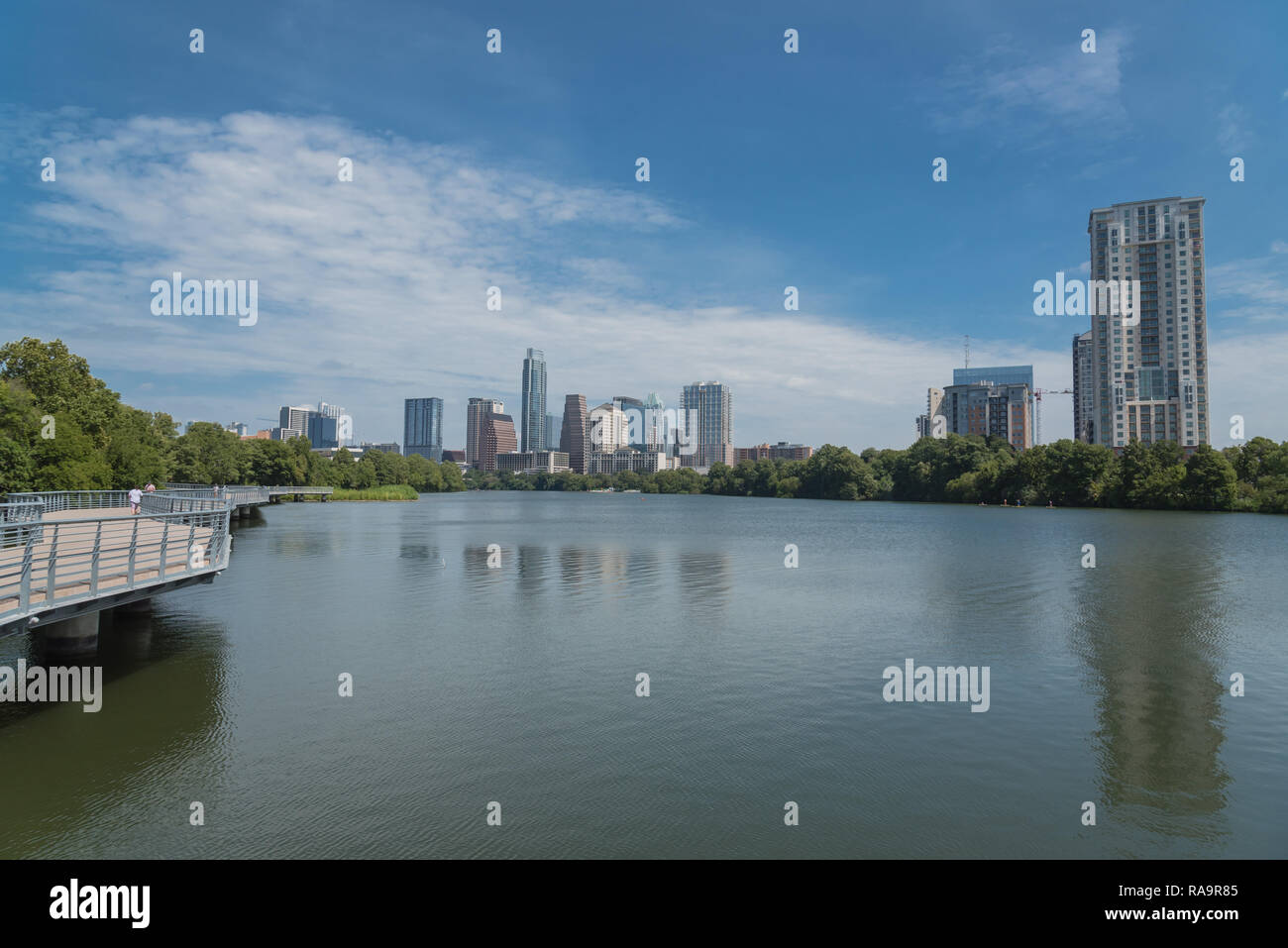 People enjoy outdoor activities on boardwalk in downtown Austin Stock