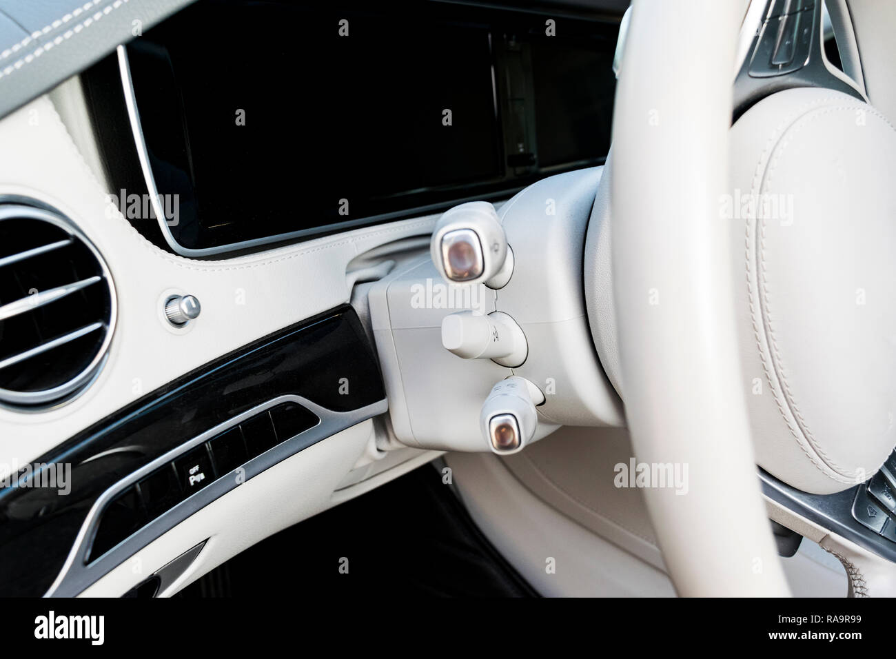 Cruise control buttons on modern car and speed limitation. White