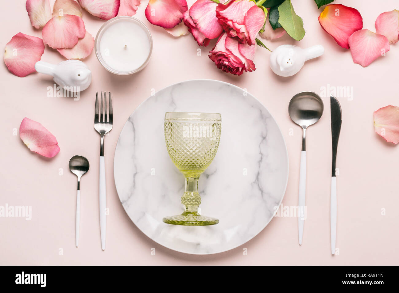 Romantic table setting in pink colors. Tableware and decorations for serving a festive table. Stock Photo