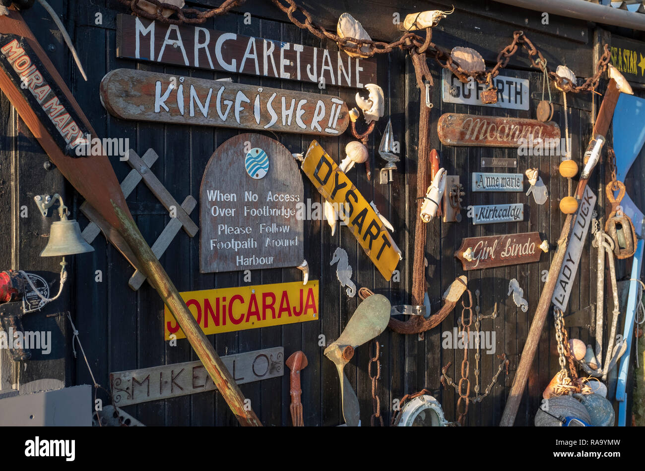 Old boat nameplates attached to a door near the harbourmasters house in Dysart, near Kirkcaldy, Scotland. Stock Photo