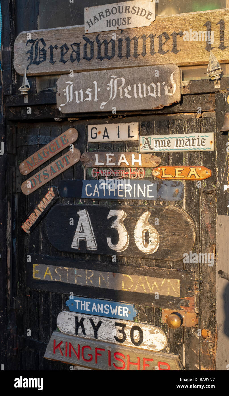 Old boat nameplates attached to a door near the harbourmasters house in Dysart, near Kirkcaldy, Scotland. Stock Photo