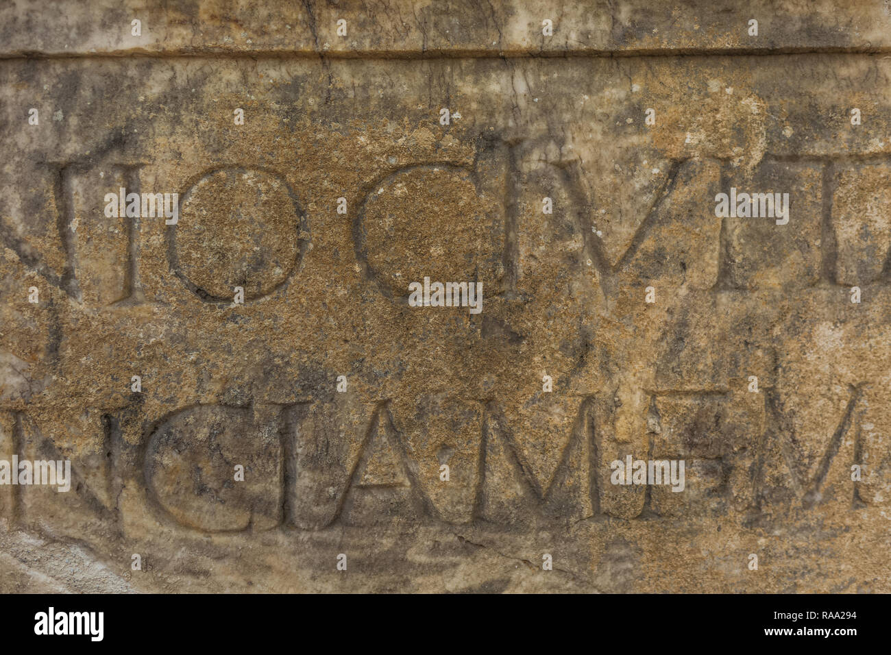 Real ancient letters cutted in stony wall of ancient architecture found during excavations of ancient ruins. Horizontal color photography. Stock Photo