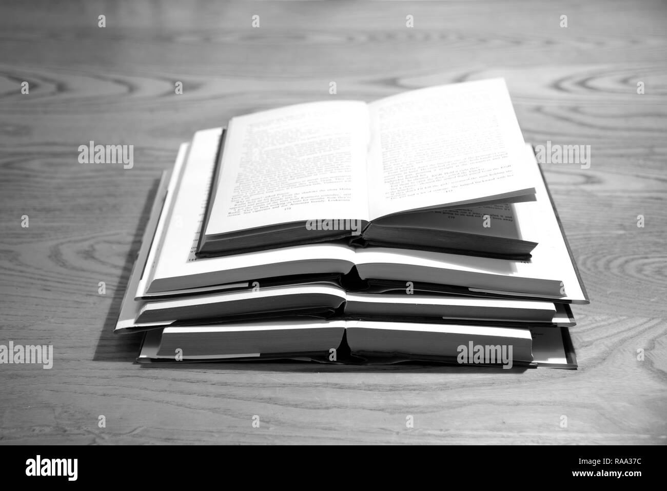 Pile of open books on a desk Stock Photo