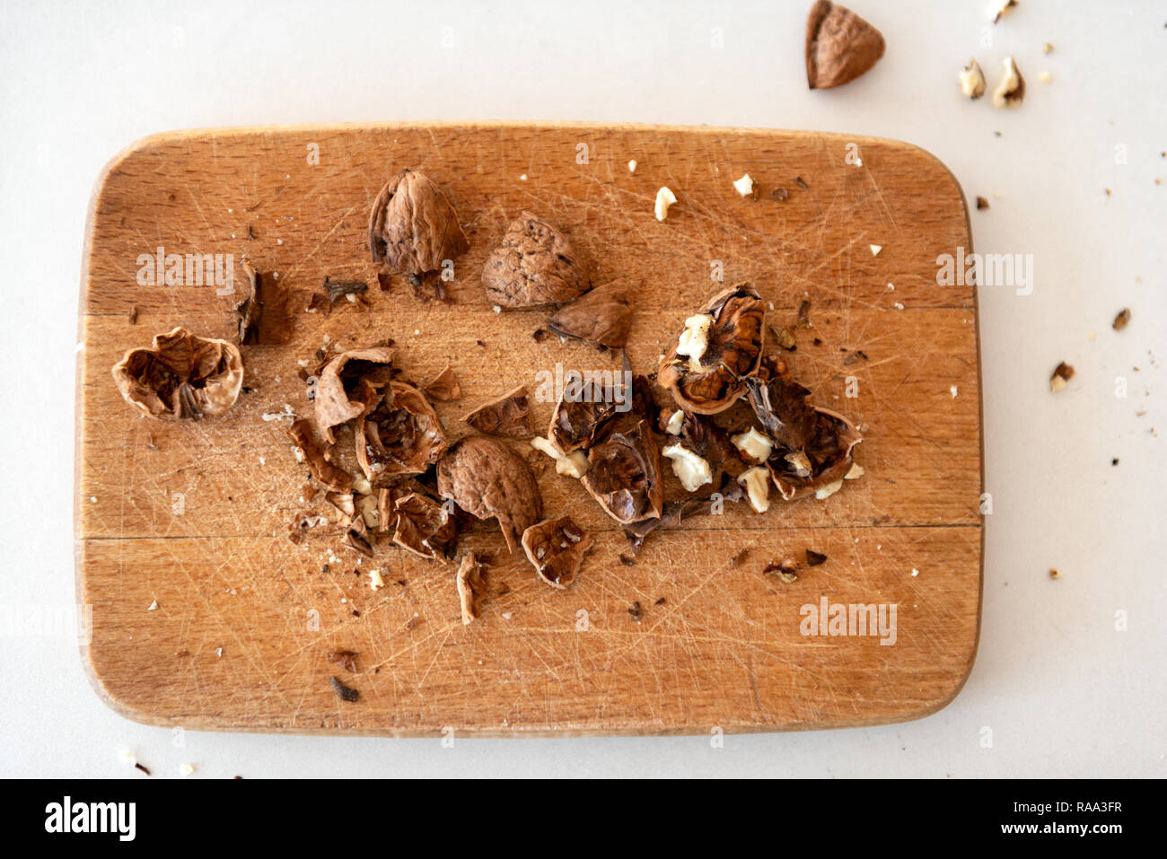 Crushed walnuts on wooden board top view Stock Photo