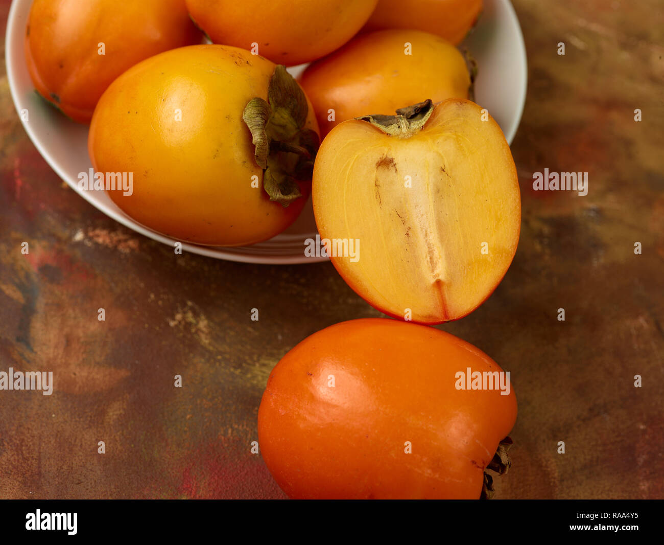 Sharon fruit against white background, food portrait Stock Photo - Alamy