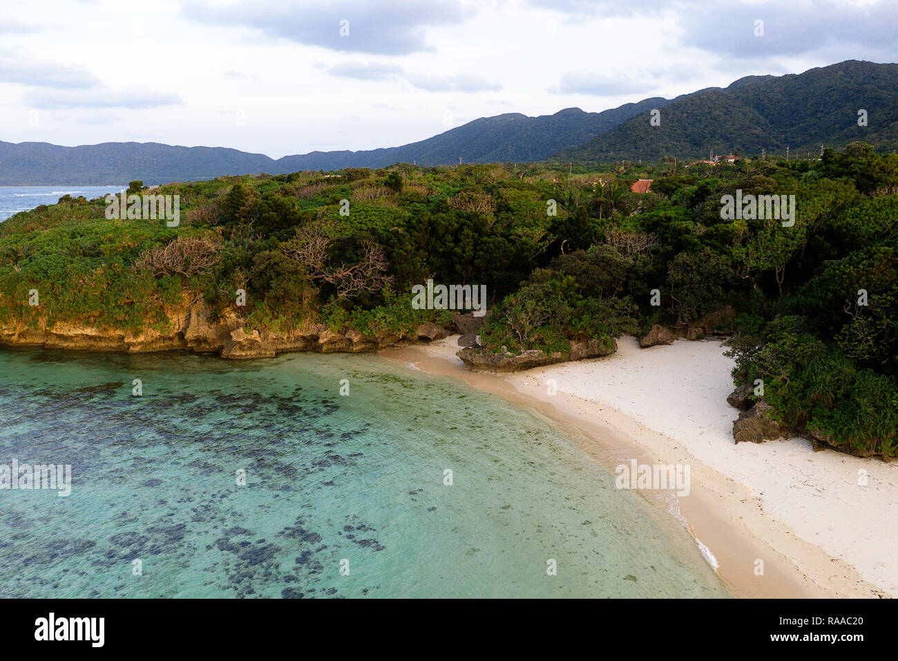 Aerial view over unique tropical island with mountains, secluded white ...