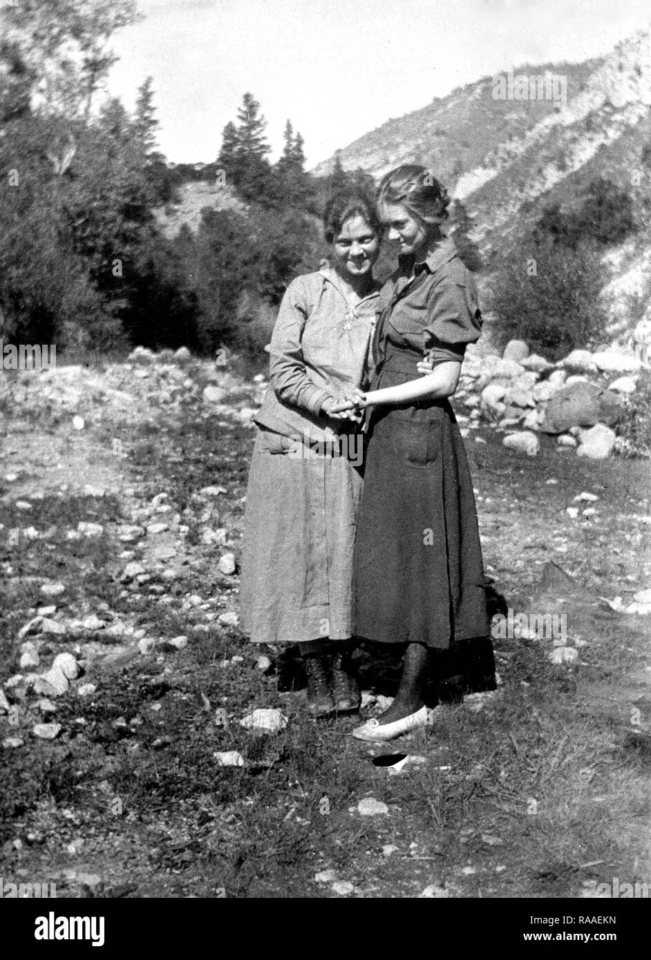 Two young women pose together holding hands in Colorado, ca. 1925. Stock Photo