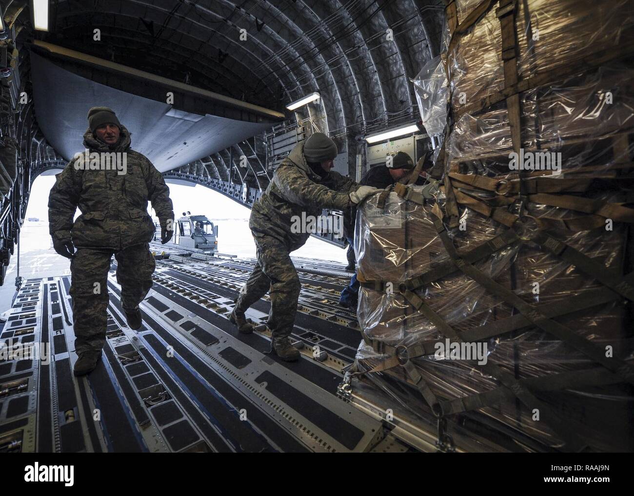 934th Airlift Wing Airmen at Minneapolis-St. Paul Air Reserve Station load humanitarian cargo onto a Joint Base Charleston C-17 Globemaster III Jan. 13, 2017. The 315th Airlift Wing flew more than 50,000 pounds of donated meals intended for refugees in northern Iraq. Stock Photo