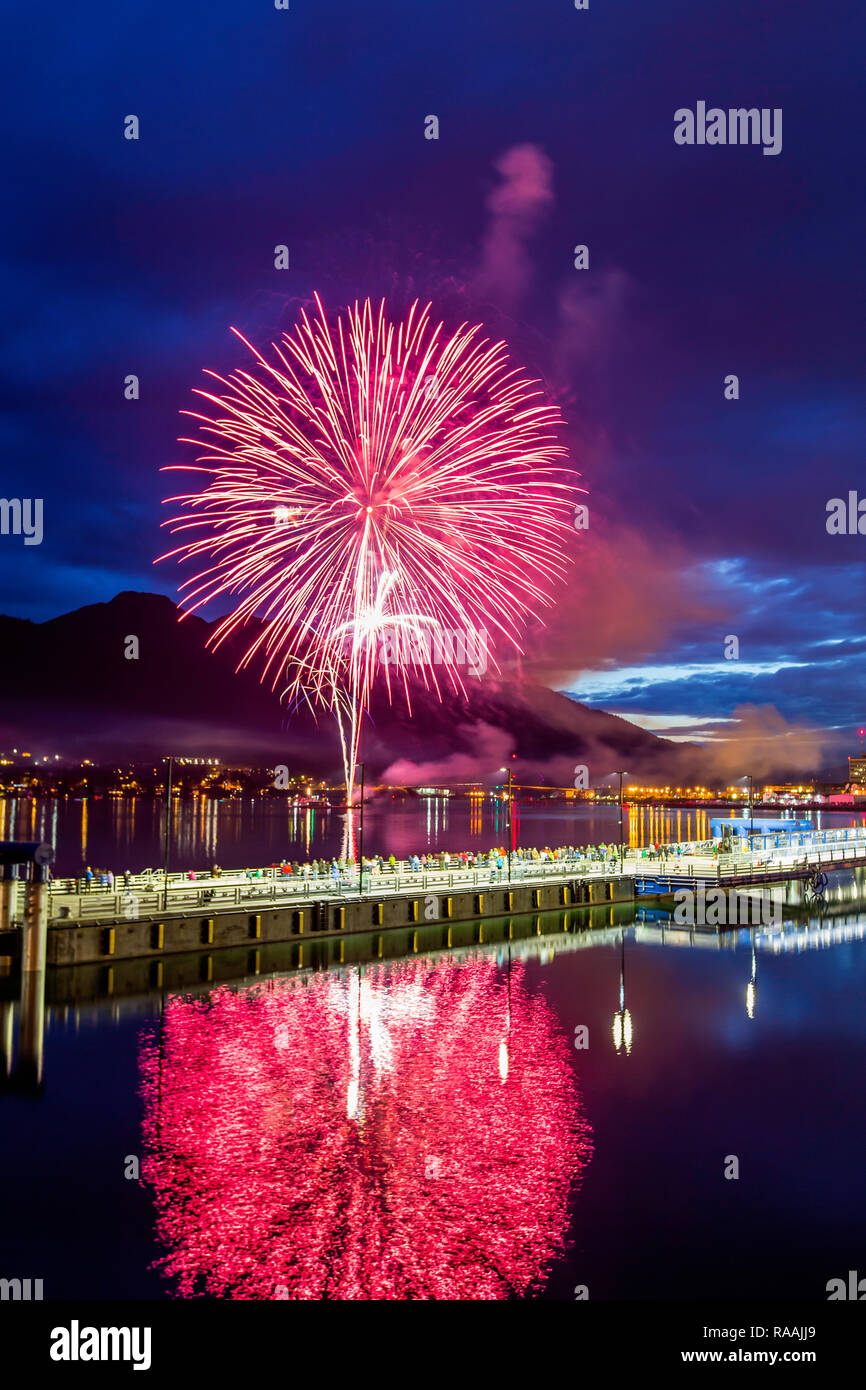 July 4th fireworks from downtown in the harbor of Juneau, Southeast Alaska, USA. Stock Photo