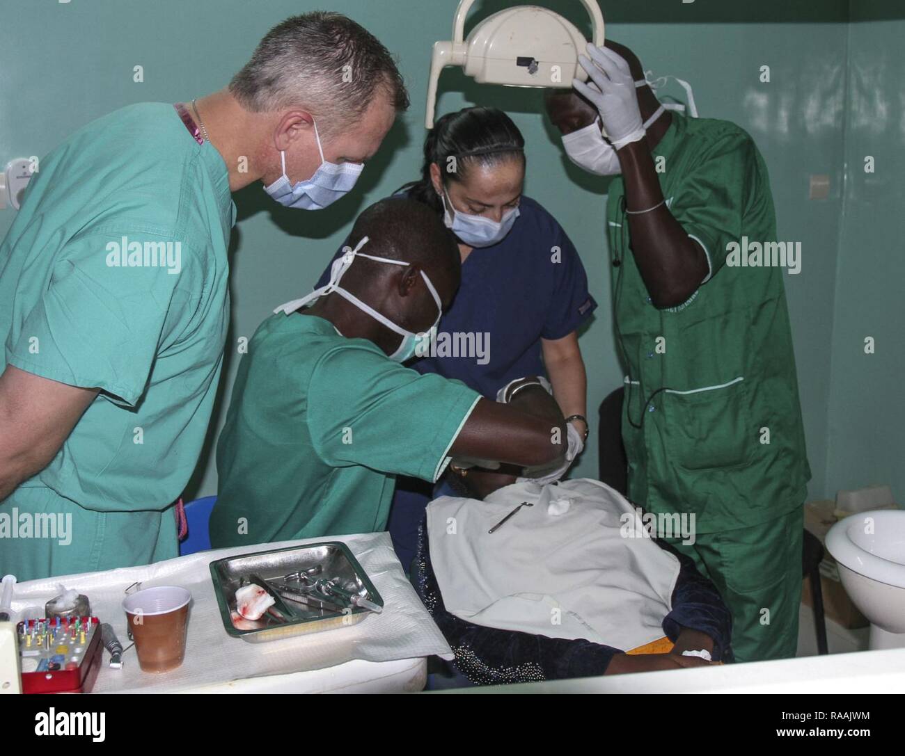 A team of U.S. military and Senegalese medical professionals examine a dental patient during Medical Readiness Training Exercise 17-1 at La Sante des Armees Hospital in Dakar, Senegal, Jan. 12, 2017. MEDRETE is a combined effort between the Senegalese government, U.S. Army Africa, the U.S. Army Reserve 332nd Medical Brigade in Nashville, Tenn., and the Vermont Air National Guard. AFRICOM’s MEDRETEs hosted by United States Army-Africa pair small teams of military medical professionals from the U.S. with participating African partner nations to train alongside and share best practices in trauma  Stock Photo